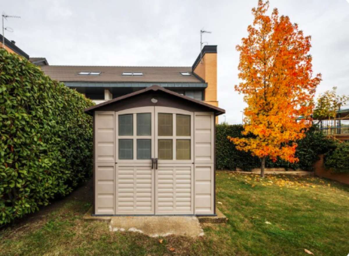 Garden storage unit with built-in lock and reinforced doors for added security.