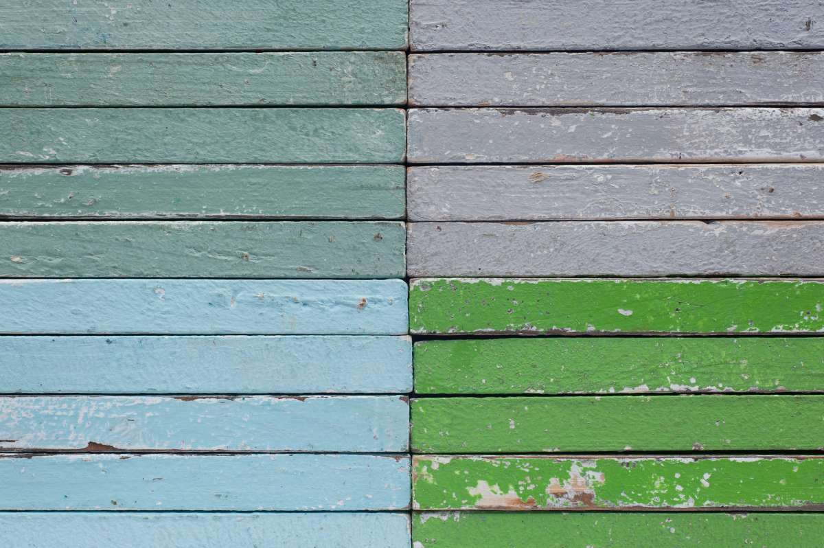 Rustic wooden garden storage unit in a landscaped garden.
