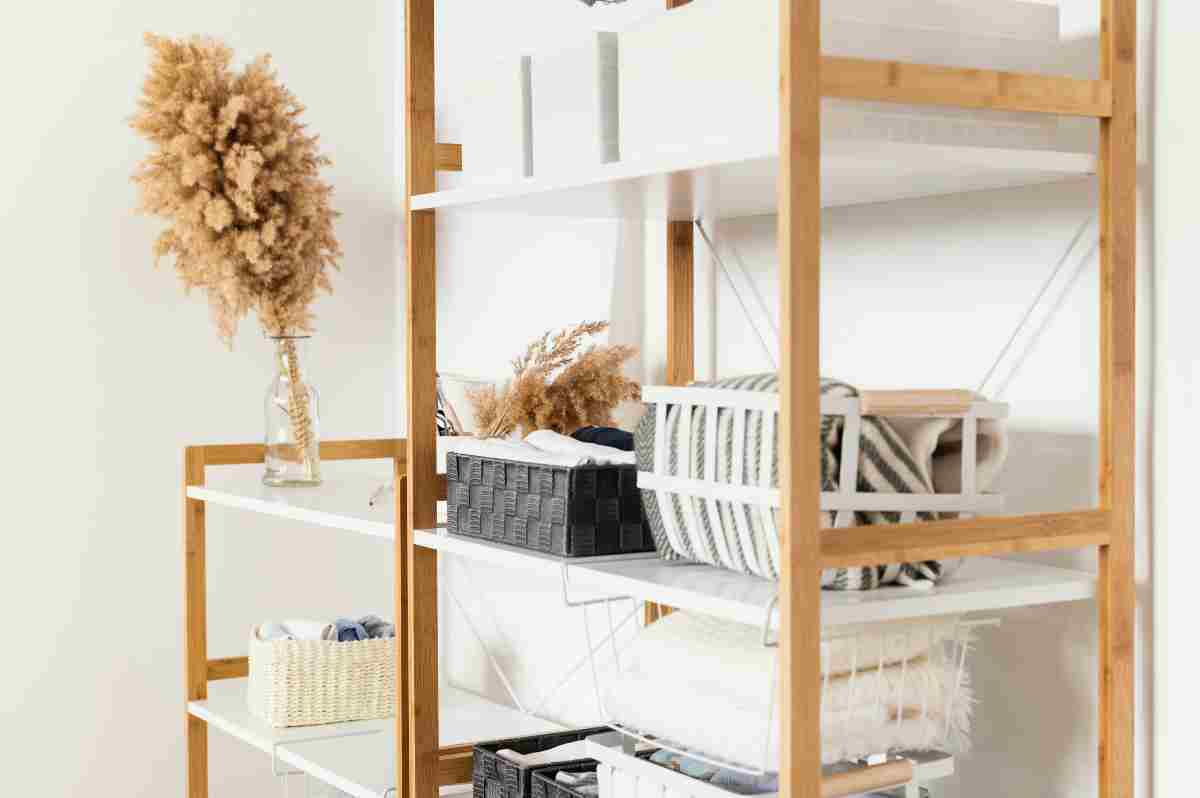 Wall-mounted shelves and hooks in an apex garden shed holding tools, gardening supplies, and equipment neatly organized.